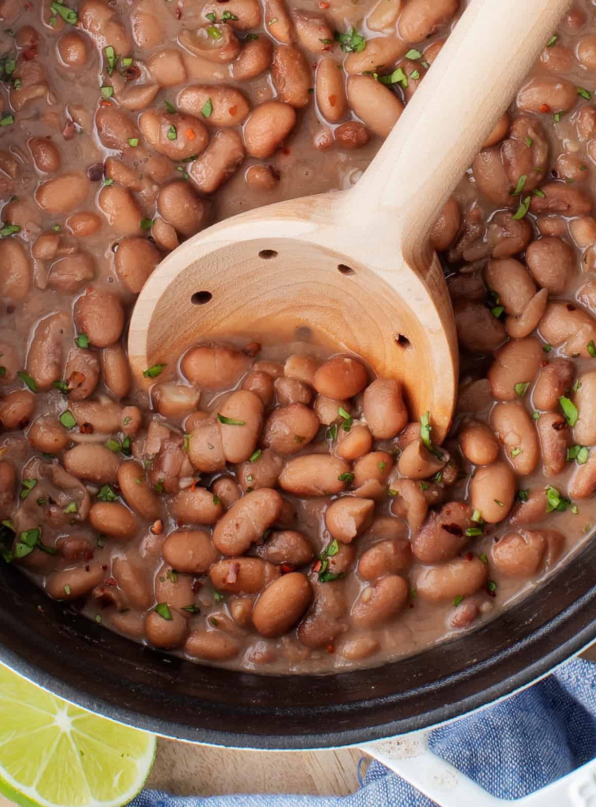 Pot of beans with wooden spoon